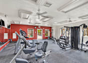 Thumbnail 16 of 23 - A gym with a variety of equipment including treadmills, weights, and exercise machines.