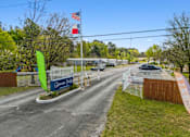 Thumbnail 2 of 8 - The entrance to Clasow Travel with a green flag and a sign.