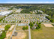 Thumbnail 4 of 8 - A bird's eye view of a residential area with houses and a large open field.