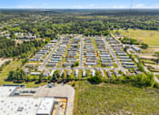 Thumbnail 5 of 8 - A large aerial view of a parking lot surrounded by buildings and trees.