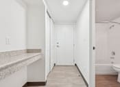 Thumbnail 19 of 45 - A white bathroom with a toilet, sink, and bathtub.