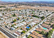 Thumbnail 4 of 23 - A large suburban neighborhood with houses and a road.
