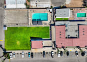Thumbnail 23 of 23 - A large grassy area in the middle of a parking lot.