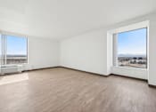 Thumbnail 15 of 45 - Empty room with a view of the cityscape outside the window.