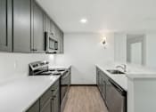 Thumbnail 21 of 45 - A kitchen with black cabinets and white countertops.