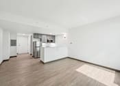 Thumbnail 24 of 45 - A kitchen with white cabinets and a wooden floor.