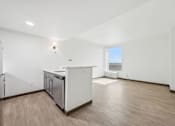 Thumbnail 12 of 45 - A kitchen with white cabinets and a wooden floor.