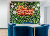 Thumbnail 1 of 45 - A green wall with flowers and the words "The Parker at Smile Station" written in neon.