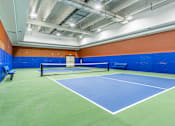 Thumbnail 38 of 45 - A tennis court with a net and two benches.