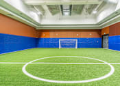 Thumbnail 8 of 45 - A basketball court with a green floor and white lines.