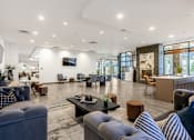 Thumbnail 45 of 45 - A modern living room with a variety of seating options and a flat screen TV mounted on the wall.