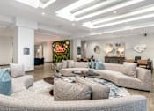 Thumbnail 39 of 45 - A modern living room with a grey sofa and a coffee table.