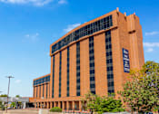 Thumbnail 3 of 45 - A large orange building with a sign that reads "Fairmont Leawood".