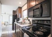 Thumbnail 1 of 16 - Model kitchen at Aldea Manufacture Home Community in Fort Worth, Texas