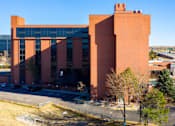 Thumbnail 10 of 45 - a large brick building with a blue sky in the background