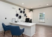 Thumbnail 17 of 20 - A white reception desk with a blue chair and a white wall with a black and white decoration.
