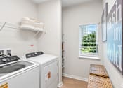 Thumbnail 37 of 41 - A laundry room with a washer and dryer.
