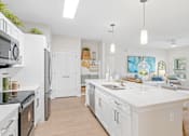 Thumbnail 31 of 41 - A modern kitchen with white cabinets and appliances.