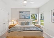 Thumbnail 34 of 41 - A bedroom with a bed, pillows, and a blanket.