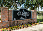 Thumbnail 22 of 26 - A sign that says Arbours at Fort King stands in front of a brick wall.
