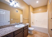 Thumbnail 17 of 26 - A bathroom with a sink, toilet, and bathtub.