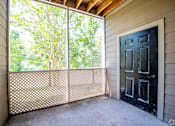 Thumbnail 6 of 26 - A black door is on the right side of a screened window.
