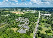 Thumbnail 5 of 26 - A suburban area with a road running through it.
