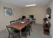 Thumbnail 23 of 32 - A conference room with a wooden table and chairs at Arbours at Tumblin Creek ~ Active 55+ Adult Community, Gainesville, FL