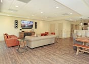 Thumbnail 20 of 32 - A living room with a couch, chairs, and a television at Arbours at Tumblin Creek ~ Active 55+ Adult Community, Florida