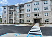 Thumbnail 5 of 21 - A large building with a parking lot in front of it.at Arbours at Moores Mill, Alabama, 35811