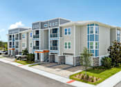 Thumbnail 2 of 41 - A modern apartment complex with multiple buildings and balconies.