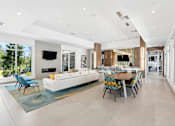 Thumbnail 21 of 41 - A modern living room with a white sofa and a blue rug.