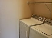 Thumbnail 10 of 18 - A washer and dryer in a small room at Arbours at Ensley Apartments, Pensacola