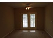 Thumbnail 12 of 18 - A room with a ceiling fan and a window with glass doors at Arbours at Ensley Apartments, Florida 32514