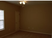 Thumbnail 13 of 18 - A room with a ceiling fan and a door at Arbours at Ensley Apartments, Pensacola, FL 32514