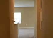 Thumbnail 14 of 18 - A hallway with a window and a door on the right at Arbours at Ensley Apartments, Pensacola, FL