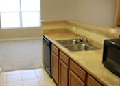 Thumbnail 15 of 18 - A kitchen with a sink and microwave at Arbours at Ensley Apartments, Pensacola, 32514