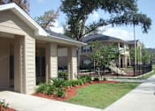 Thumbnail 5 of 18 - A row of houses with a sidewalk in front at Arbours at Ensley Apartments, Florida 32514