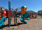 Thumbnail 1 of 5 - A playground with a blue slide and orange and green play structures at Arbours at Lake Charles, Lake Charles, LA, 70605 