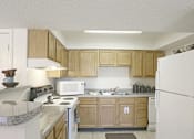 Thumbnail 16 of 21 - A Kitchen With Wooden Cabinets at Magnolia Court Apartments, Birmingham, AL