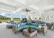 Thumbnail 7 of 41 - A spacious outdoor living room with a sofa set and a ceiling fan.