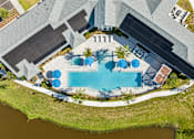 Thumbnail 12 of 41 - An aerial view of a house with a pool and a patio area.