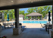Thumbnail 3 of 17 - A patio with a pool and a gazebo.
