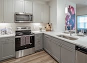 Thumbnail 31 of 55 - Kitchen with white cabinets at Alys Crossing Apartments, Cypress, Texas