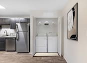 Thumbnail 21 of 52 - a washer and dryer in a laundry room with a refrigerator at Riverchase Landing, Alabama, 35244
