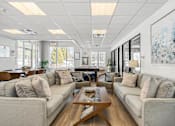 Thumbnail 2 of 27 - A spacious living room with a large couch and a coffee table. at Chatham Hill, New Jersey, 07928