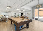 Thumbnail 4 of 27 - A pool table is in the middle of a room with a white ceiling and a door to the right. at Chatham Hill, New Jersey, 07928