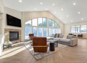 Thumbnail 6 of 51 - a living room with a couch and a chair and a fireplace at Copper and Quarry Village, Maryland, 21209