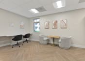Thumbnail 11 of 51 - a waiting room with chairs and a table in front of a window at Copper and Quarry Village, Maryland, 21209