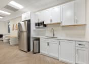 Thumbnail 10 of 51 - a kitchen with white cabinets and a stainless steel refrigerator at Copper and Quarry Village, Pikesville, MD, 21209
